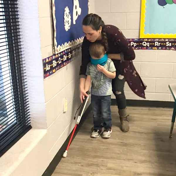 Miss Brittany showing how to use blind guide cane