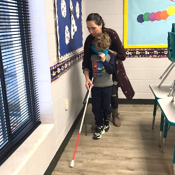 Miss Brittany showing how to use blind guide cane