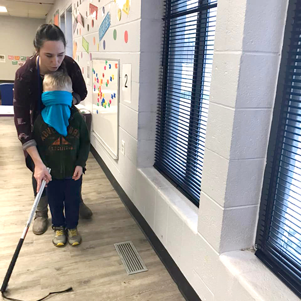 Miss Brittany showing how to use blind guide cane