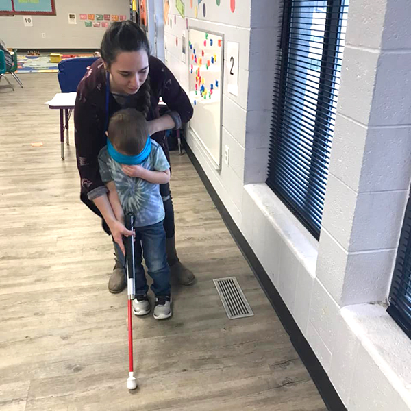 Miss Brittany showing how to use blind guide cane